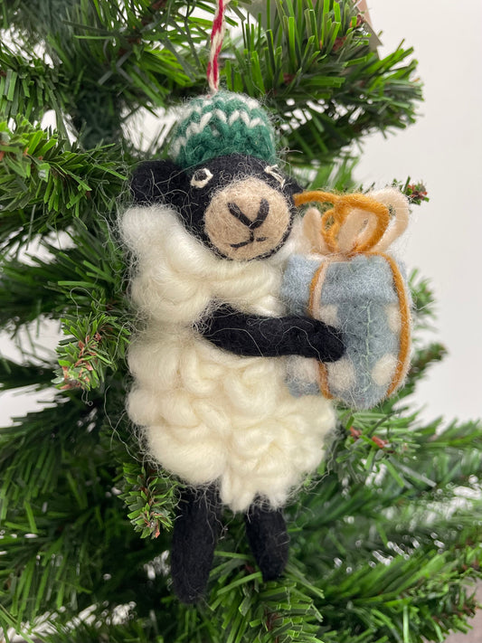 100% wool felt Christmas Ornament of a cute little Black Sheep holding a gift.